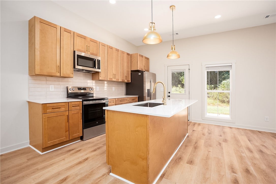 1431 Ashford Court, Auburn, AL 36830, Warm wood cabinetry and a central island ground th
