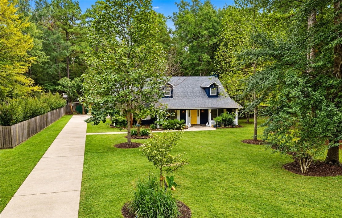 2329 Rockdell Ln, Auburn, AL 36830, A long concrete driveway guides you through a gree