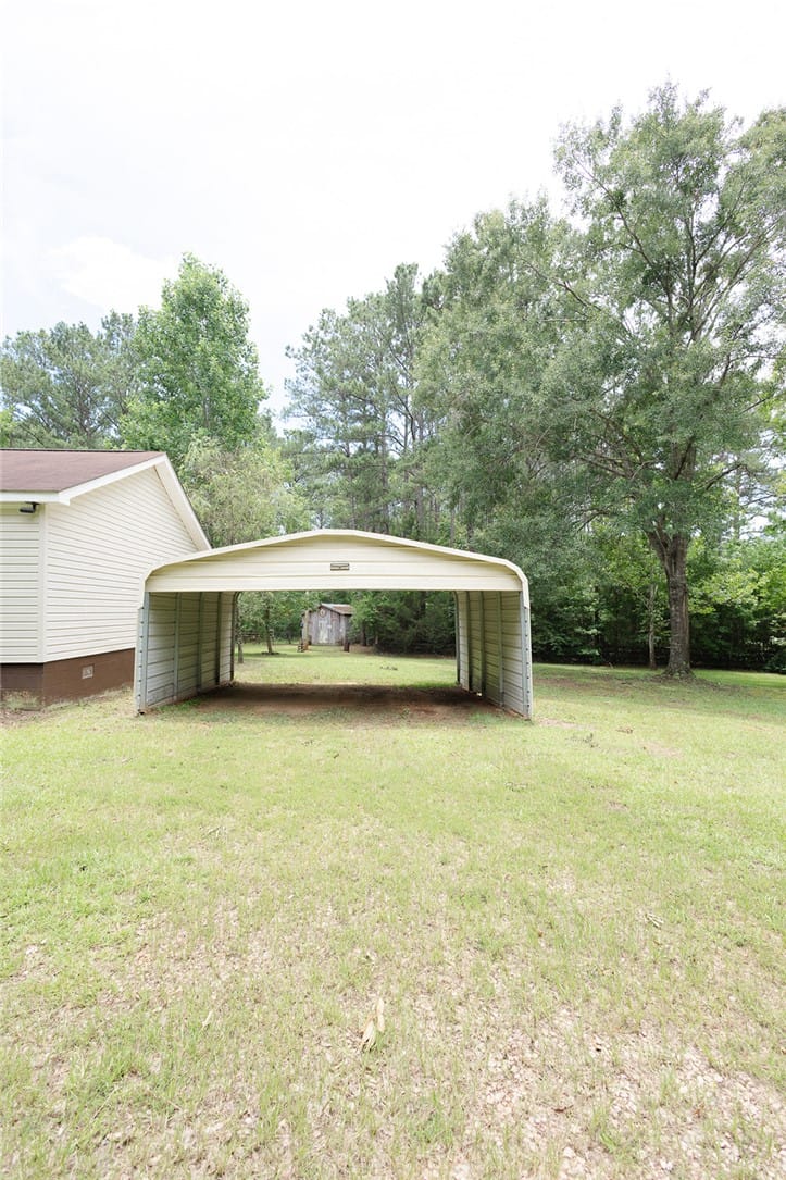 3499 Co Rd 388, Valley, AL 36854, A detached carport offers practical shelter for ve