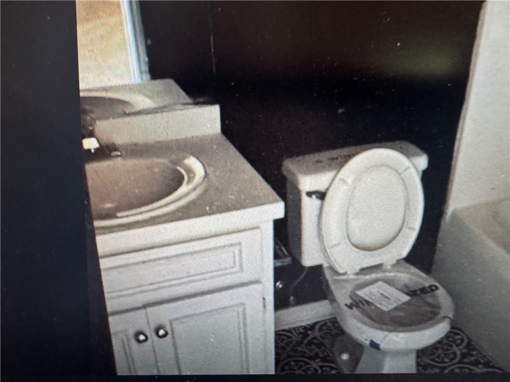 529 Mimosa Rd, Phenix City, AL 36870, This bathroom features a sleek vanity and commode,