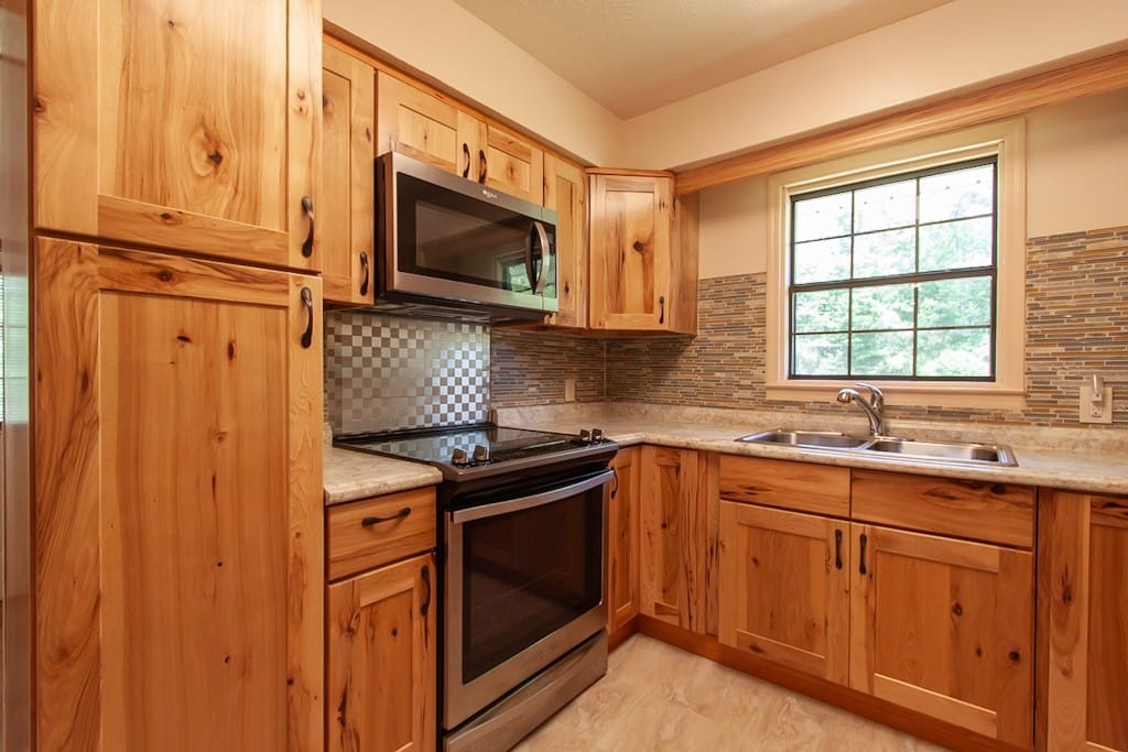 24 Lee County Rd 421, Opelika, AL 36804, Kitchen with electric range and pantry cabinet.