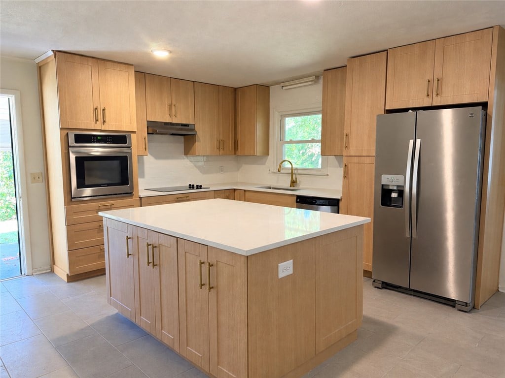 402 Highland Ave, Opelika, AL 36801, Ample wooden cabinetry and a central prep island a