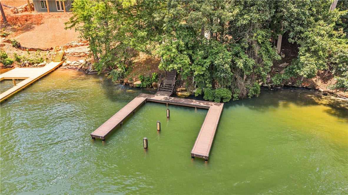 543 Elks Pkwy, Alexander City, AL 35010, A private boat dock extends into tranquil green wa