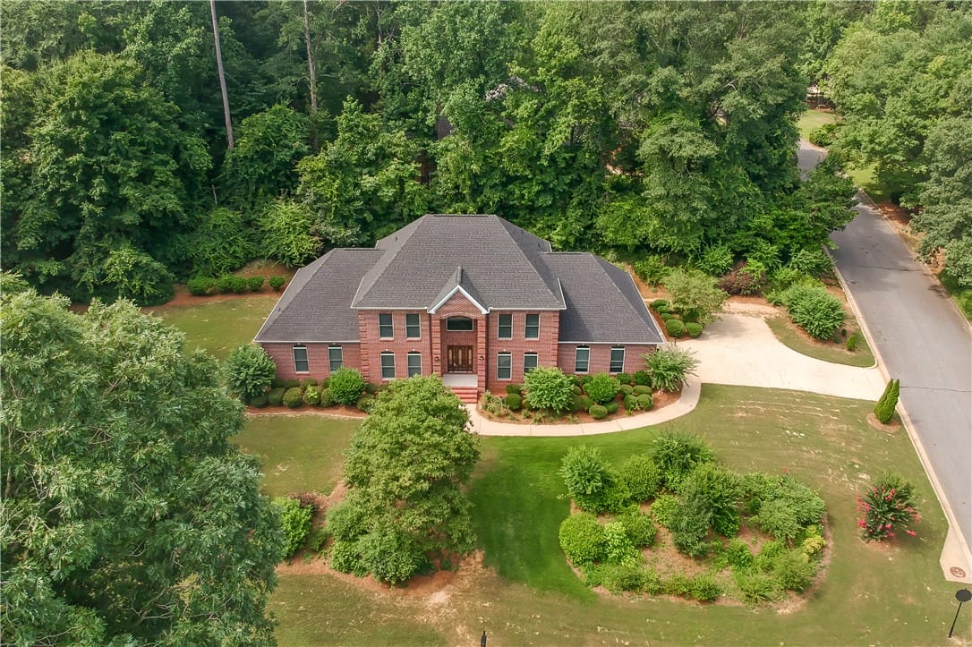 202 Asheton Ln, Auburn, AL 36830, Mature trees and lush landscaping frame this grand
