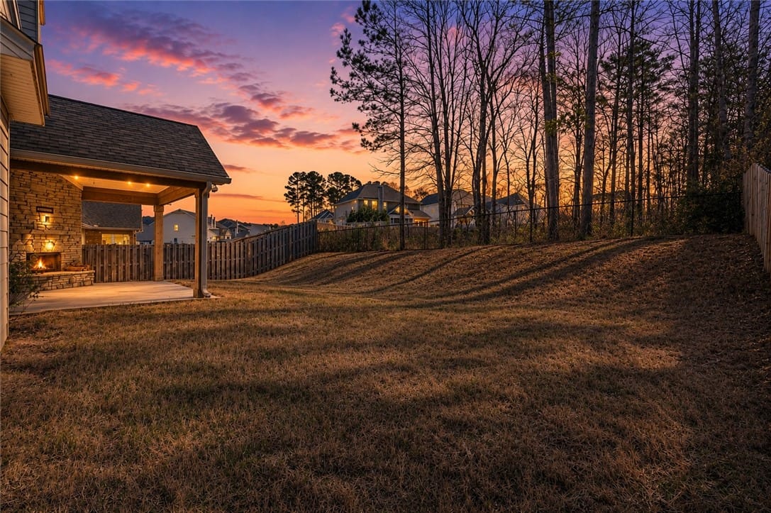 1000 Dunkirk Cir, Auburn, AL 36832, An inviting covered patio with a built-in fireplac