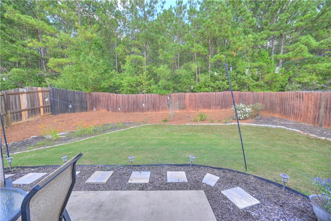 2706 Brittany Ln, Opelika, AL 36804, A spacious lawn area meets a natural tree line bey