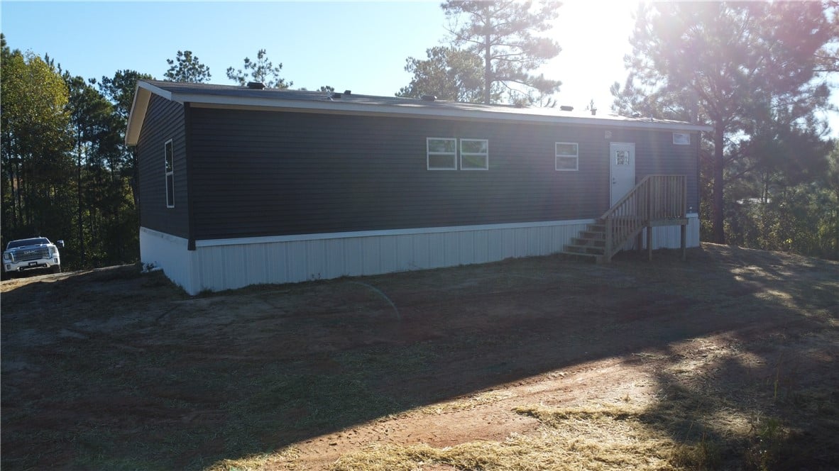 181 Heard Hill Cutoff, Jackson's Gap, AL 36861, Mature trees frame a modern manufactured home feat