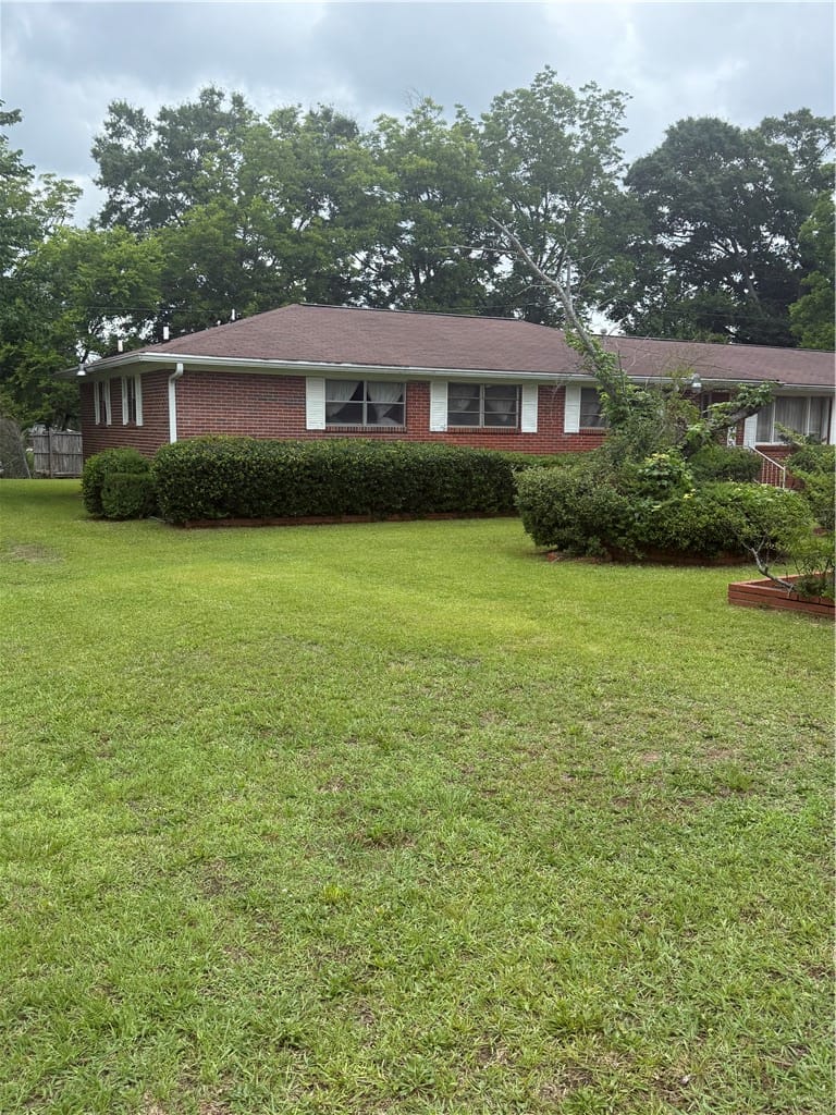 1694 18th St SW, Lanett, AL 36863, A classic brick exterior with well-maintained land