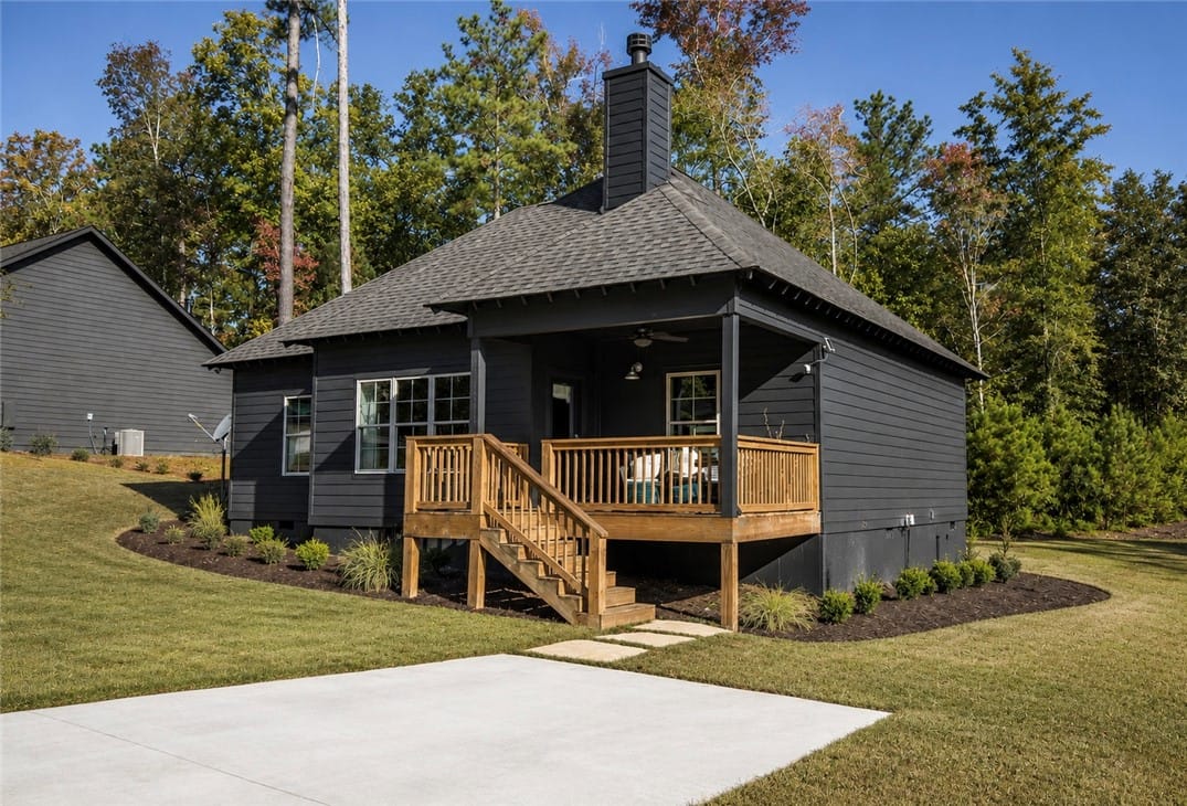 137 Williamson Trce, Tallassee, AL 36078, A dark-toned dwelling featuring a covered deck and