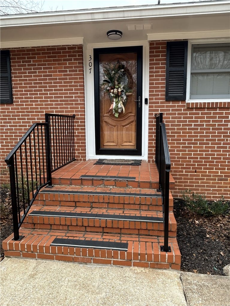 307 Highland Ave, Opelika, AL 36801, A classic brick facade welcomes with a polished wo