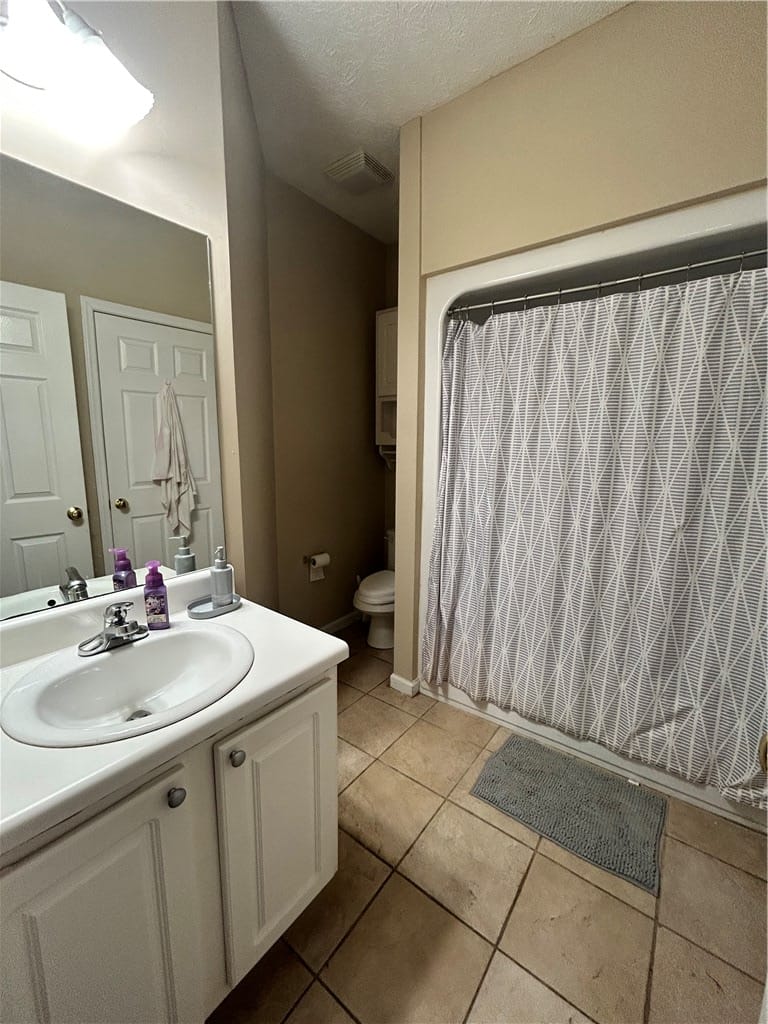 389 Jack Hampton Dr, Auburn, AL 36830, This bathroom features a simple vanity, tiled floo