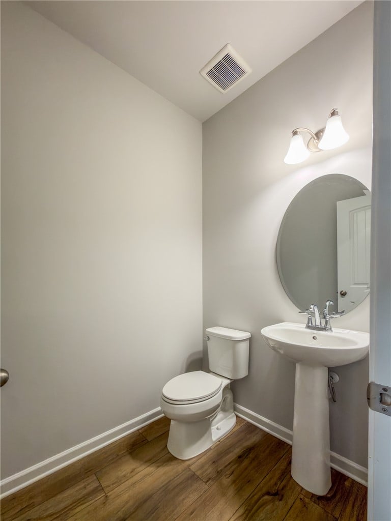 2559 Arlee Ave, Opelika, AL 36804, Rich wood flooring anchors this classic powder roo