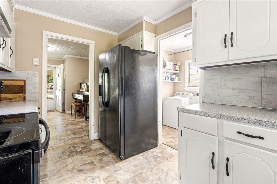 2531 55th St W, Valley, AL 36854, A functional kitchen provides direct access to a d