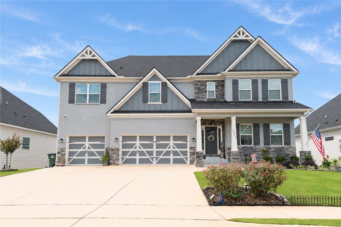 1859 Solamere Ct, Auburn, AL 36832, Gable rooflines and stone accents define this mode