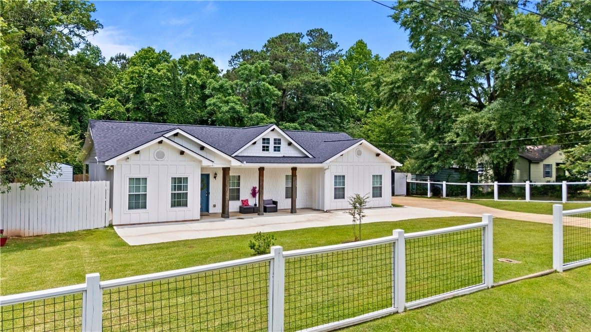 625 Howard St, Auburn, AL 36832, White siding and dark roofline adorn this inviting