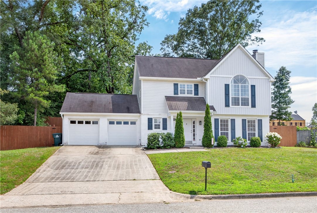 1030 Birch Cir, Auburn, AL 36830, White siding with blue shutters frames a welcoming