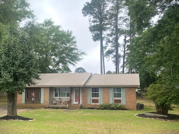 1603 Bruce Ave, Opelika, AL 36801, A charming brick dwelling framed by mature trees,