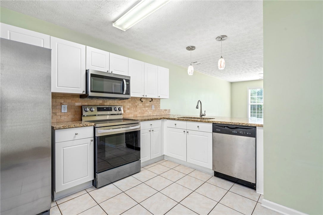 1477 N Donahue Dr, Auburn, AL 36830, White cabinetry and durable stone countertops fram