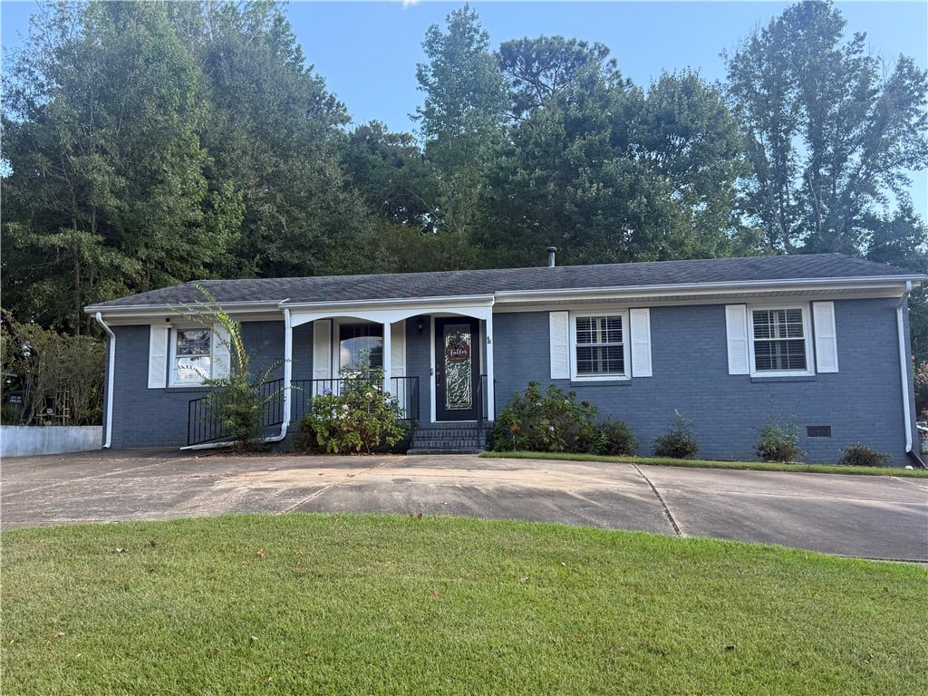 1811 Jollit Ave, Opelika, AL 36801, A classic brick facade is enhanced by clean shutte