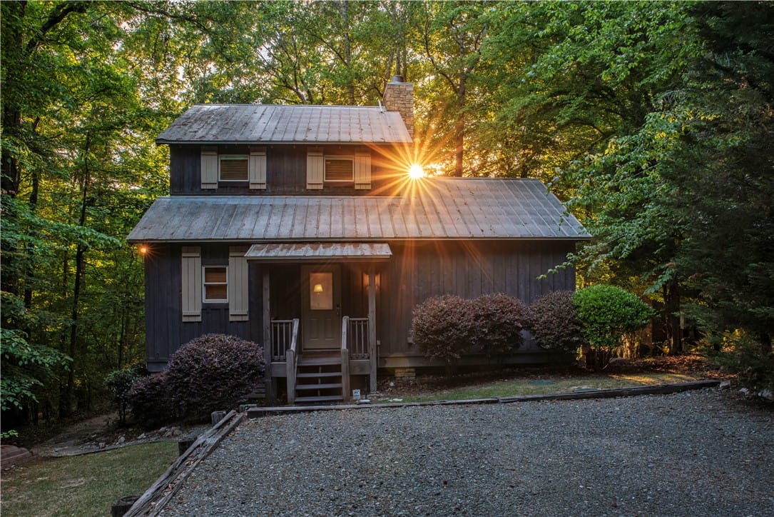 51 Falling Water Dr, Dadeville, AL 36853, This charming home is nestled among a lush forest,
