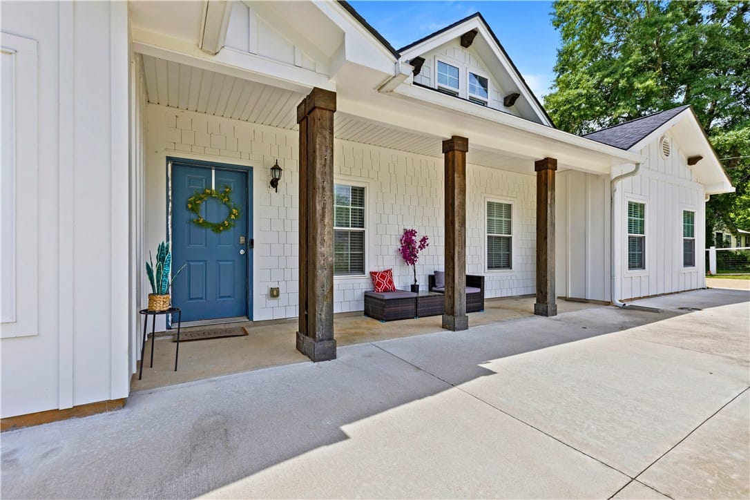 625 Howard St, Auburn, AL 36832, A welcoming covered porch with rustic wooden colum