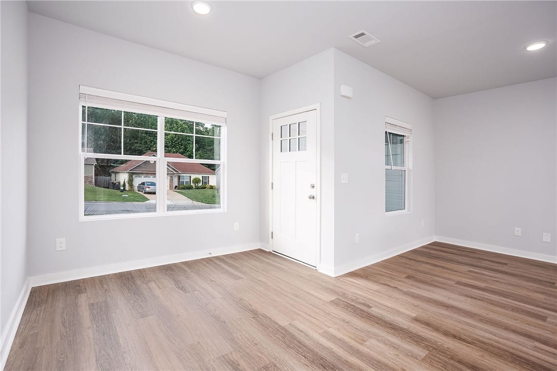 2135 Cobblestone Dr, Opelika, AL 36804, A sun-filled room offers modern wood-look flooring