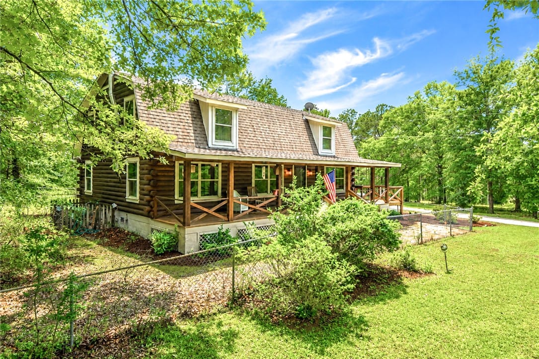 1504 Grand National Pkwy, Opelika, AL 36801, A classic log cabin style home, nestled amongst lu
