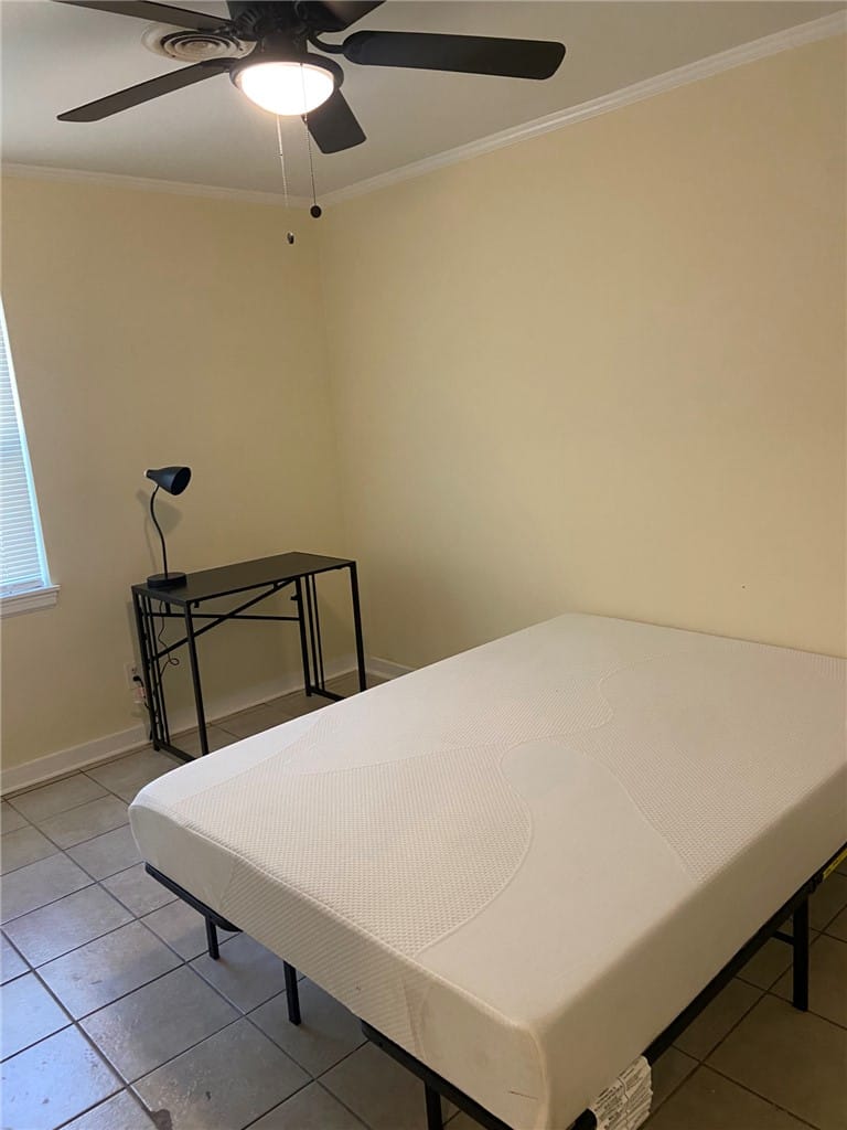 1103 Bibb St, Tuskegee, AL 36088, A comfortable bedroom with tile flooring, featurin