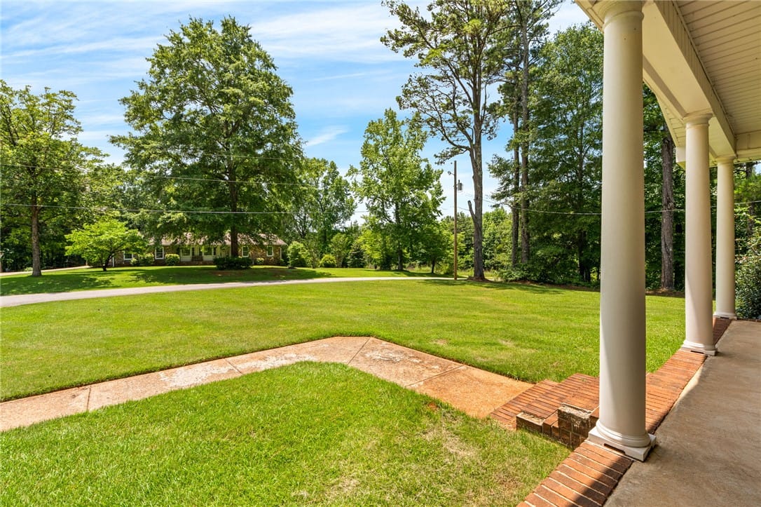 516 Pinecrest Dr E, La Fayette, AL 36862, A classic covered porch with stately columns overl