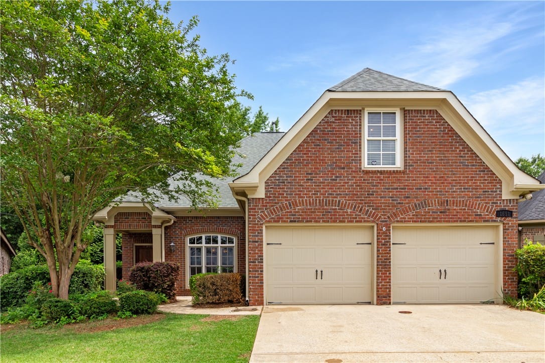 1651 Overhill Ct, Auburn, AL 36830, A classic brick exterior with inviting arched gara