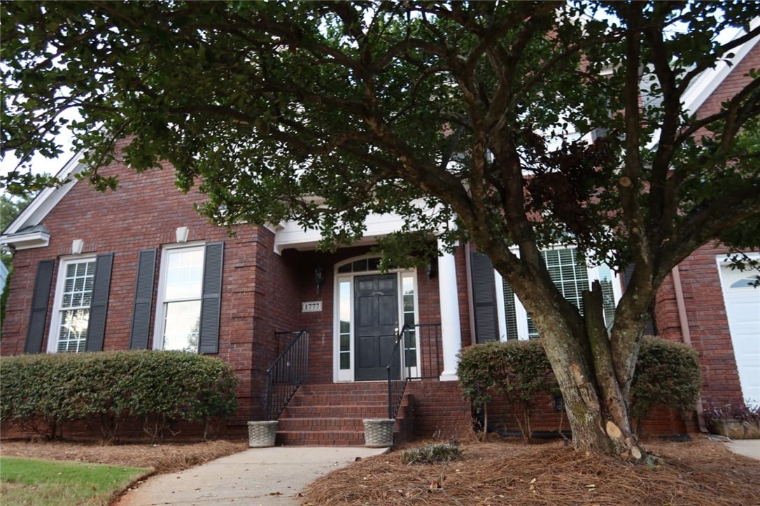 1777 Woodley Rd, Auburn, AL 36830, Mature trees shade the classic brick exterior and