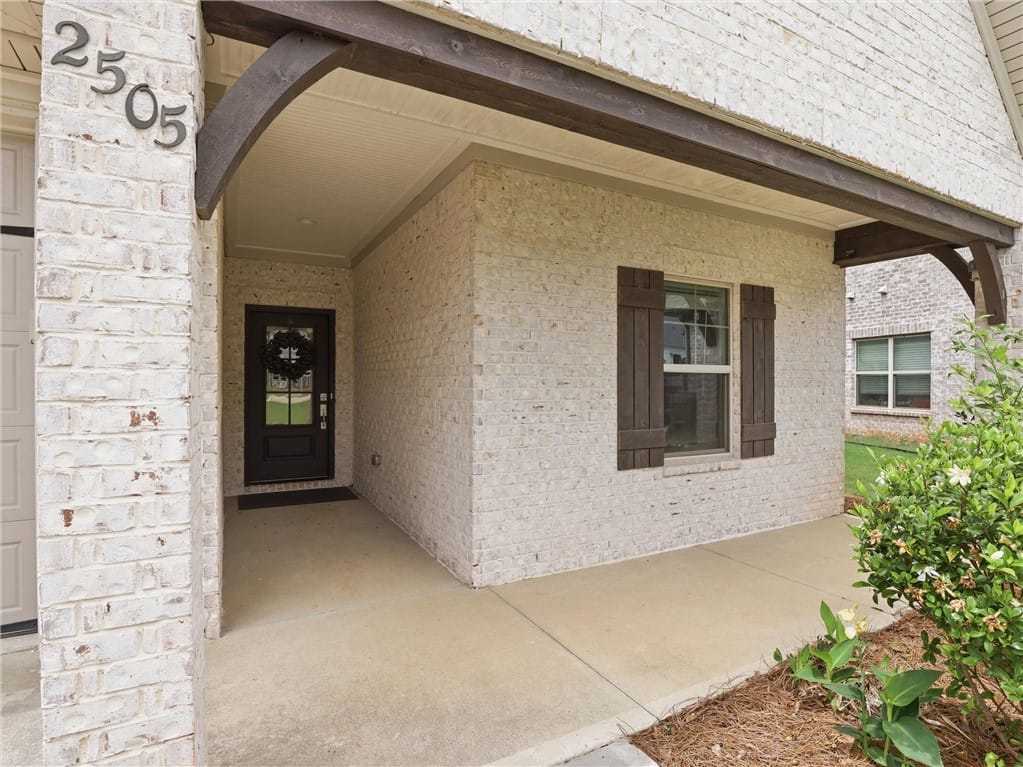 2505 Saddleback Ct, Auburn, AL 36830, A welcoming front entry features white brick, dark