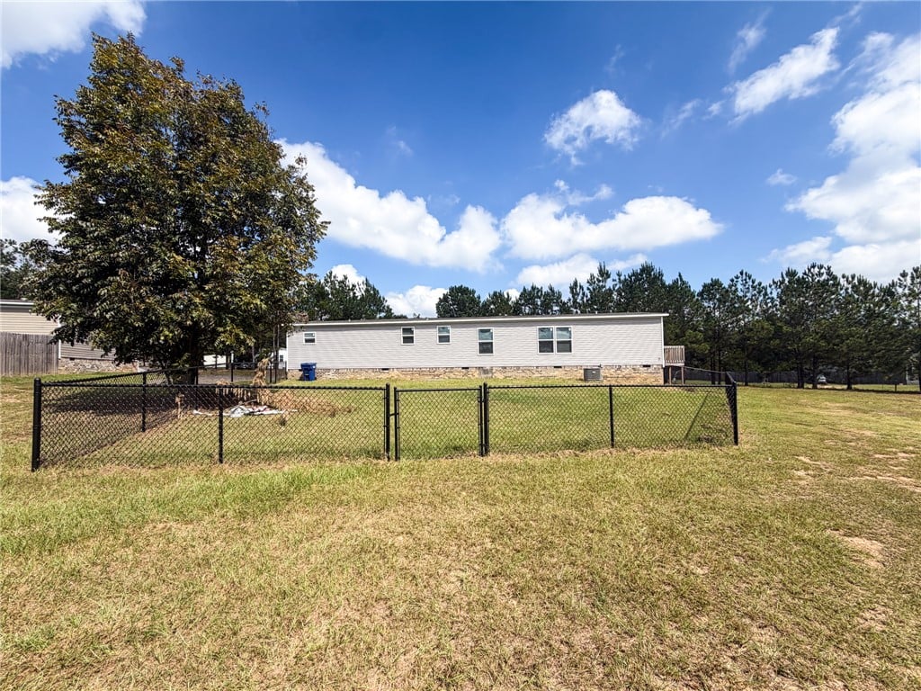 140 Lee Rd #2166, Salem, AL 36874, A spacious grassy lawn features a fenced enclosure