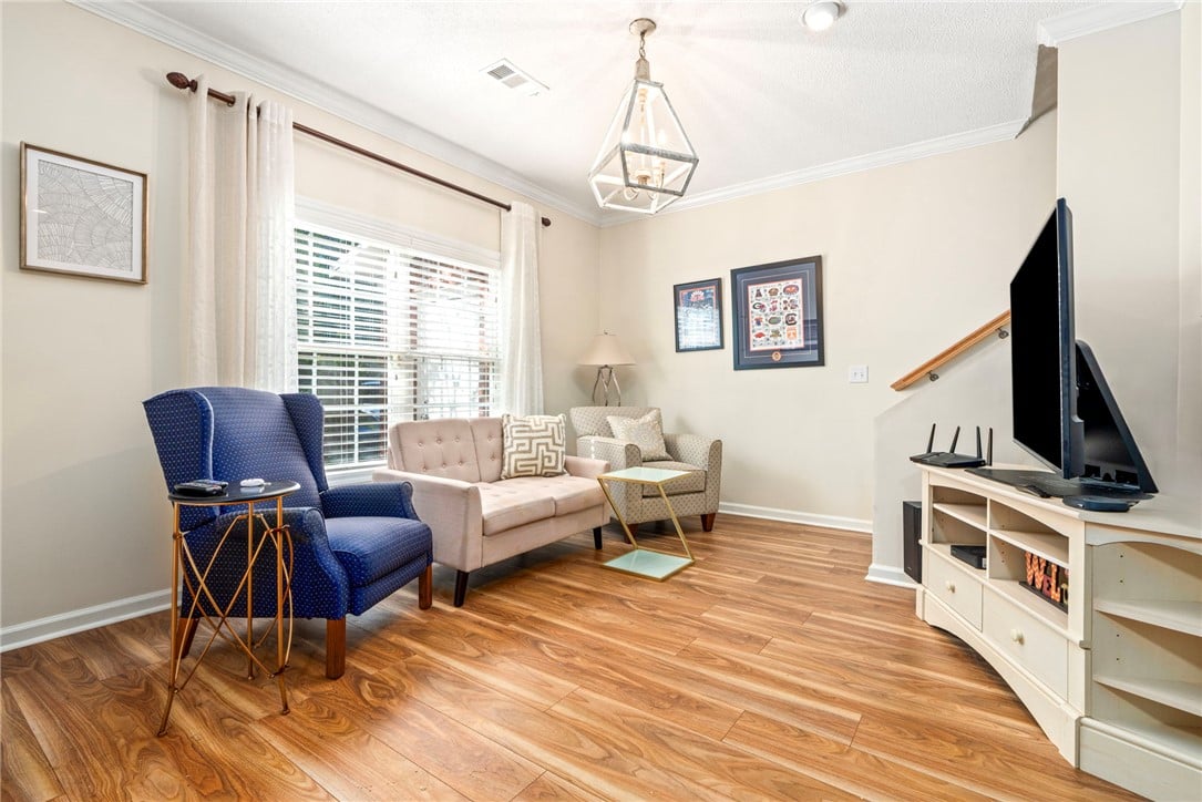 1420 S Donahue Dr B, Auburn, AL 36832, Rich wood-toned flooring and classic crown molding