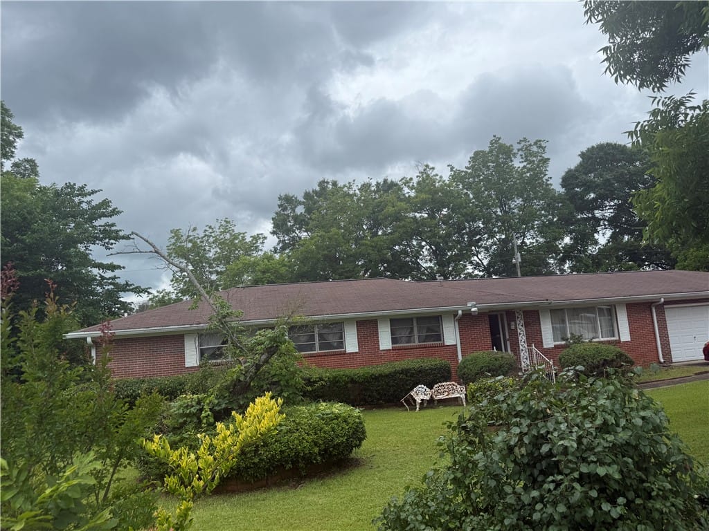 1694 18th St SW, Lanett, AL 36863, Brick facade home featuring a lush front lawn and