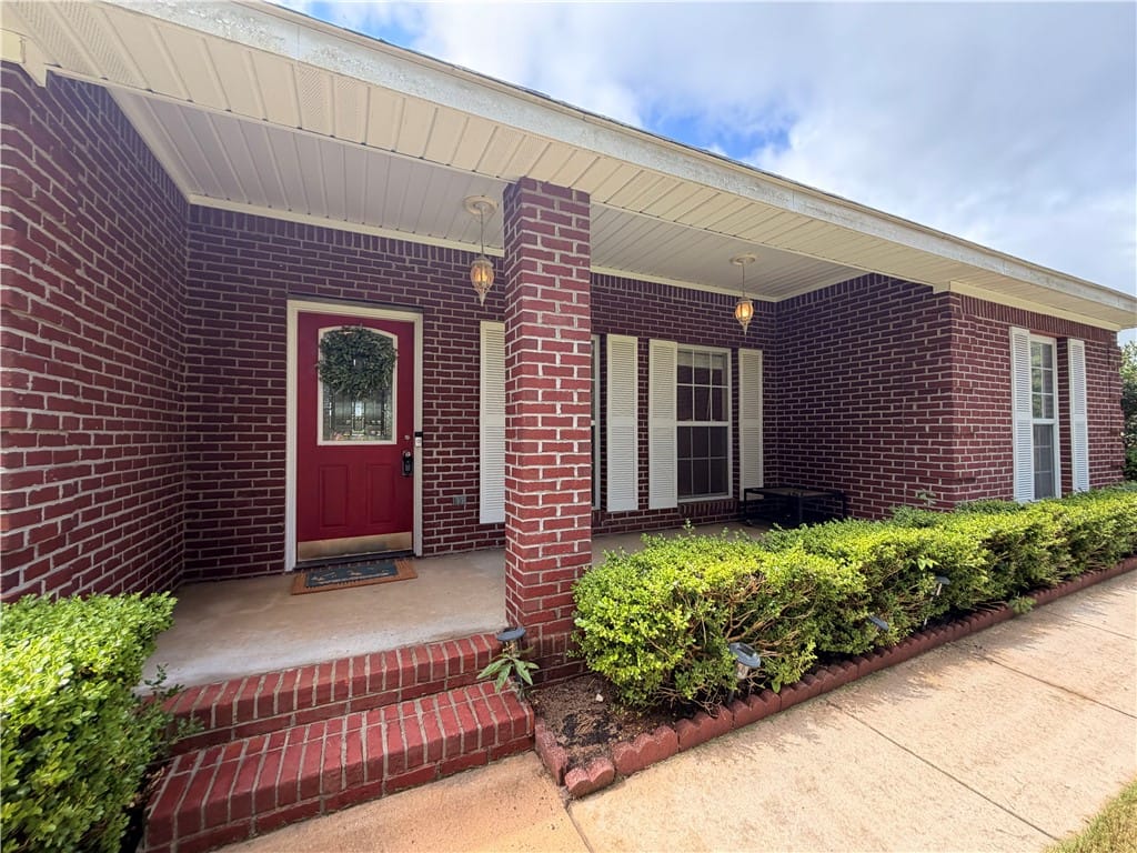 150 LEE ROAD 2056, Salem, AL, 36874, A welcoming brick facade with a vibrant red door o