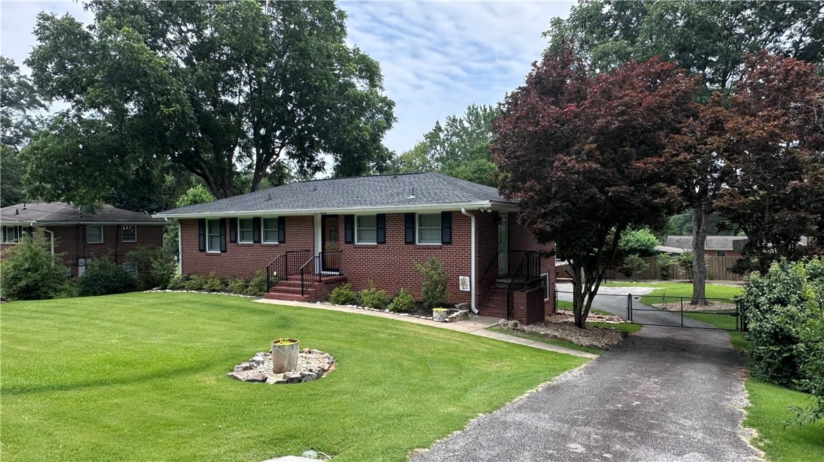 307 Highland Ave, Opelika, AL 36801, A classic brick exterior offers timeless appeal wi