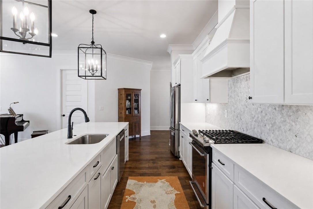 604 Overbrook Ln, Auburn, AL 36830, The kitchen's white cabinetry and countertops are