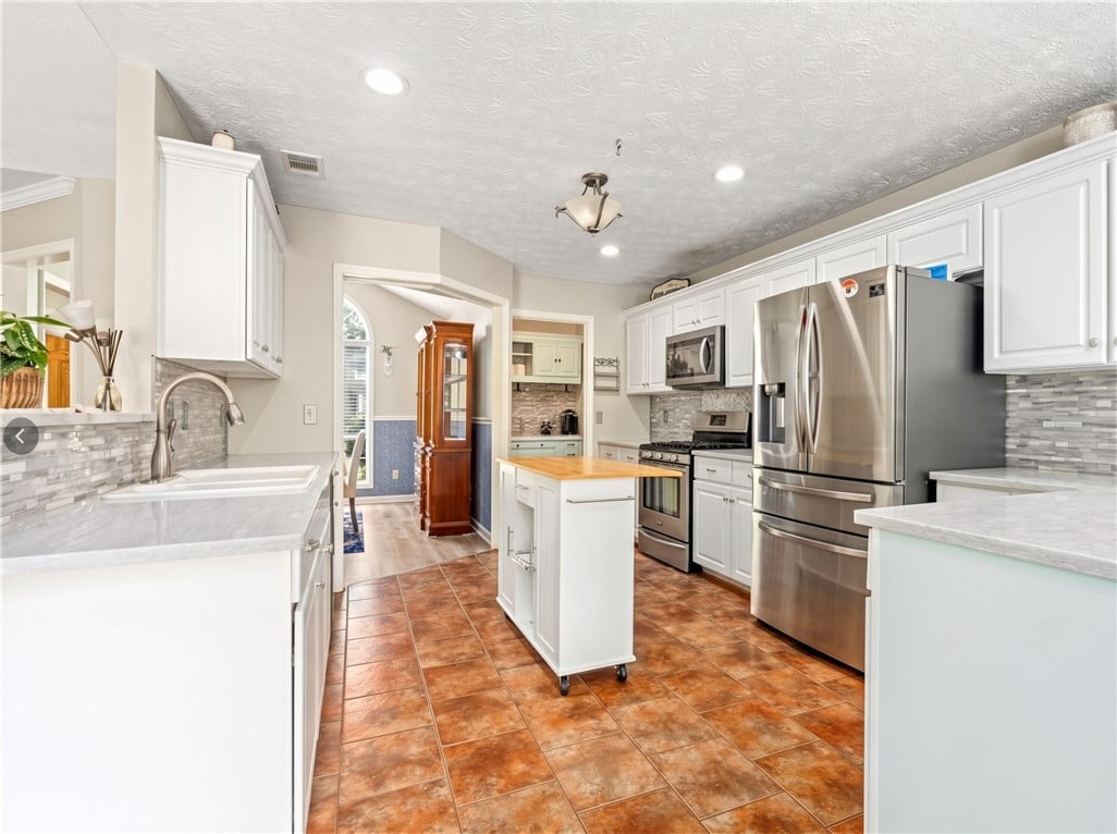 2481 Buckhead Rd, Auburn, AL 36832, Warm floor tiles anchor this modern kitchen featur