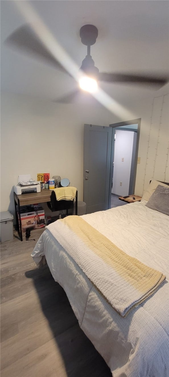 404 Patterson St, Tuskegee, AL 36088, A comfortable bedroom features modern wood-look fl