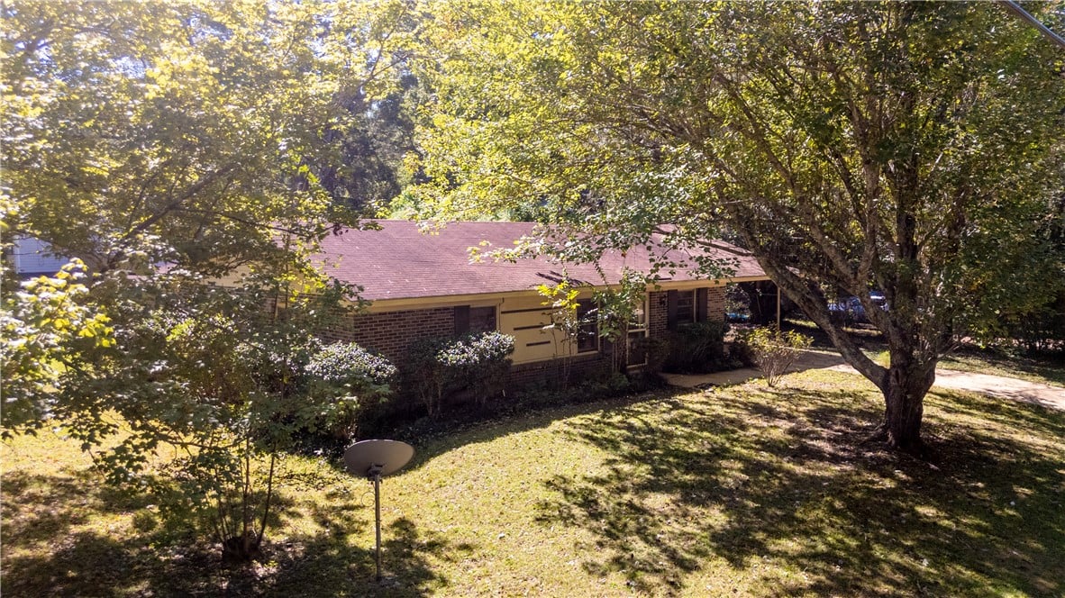 950 McKinley Ave, Auburn, AL 36830, Mature trees frame this classic brick-front home f