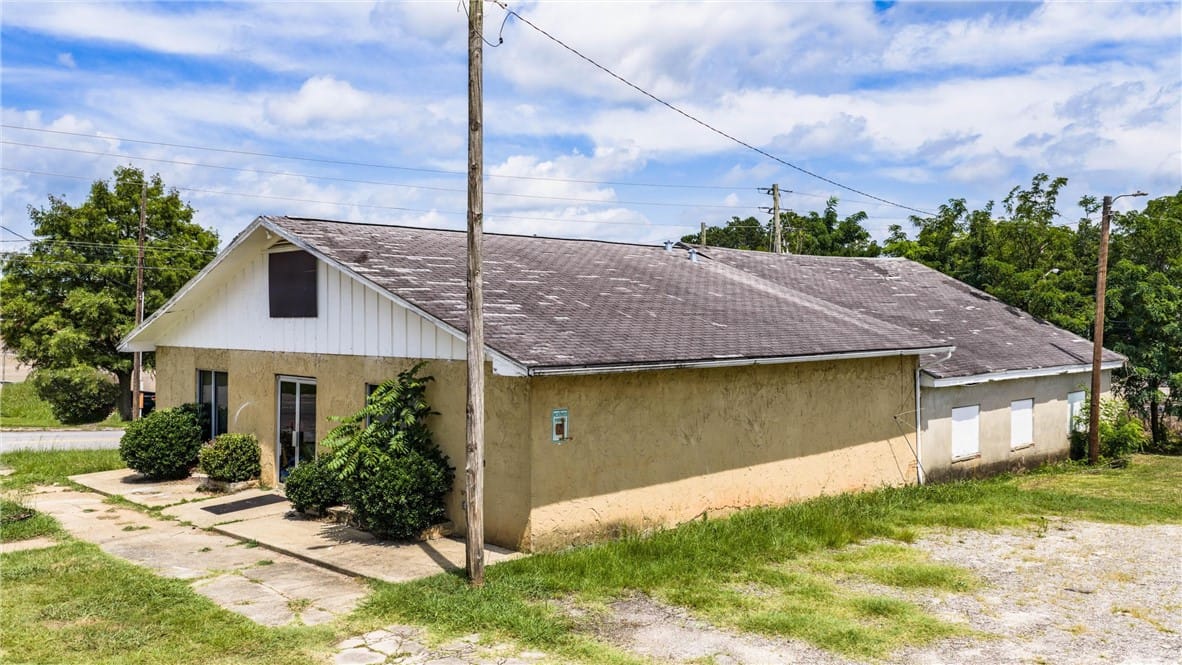 58 1st St NW, La Fayette, AL 36862, A modest stucco exterior with multiple windows and