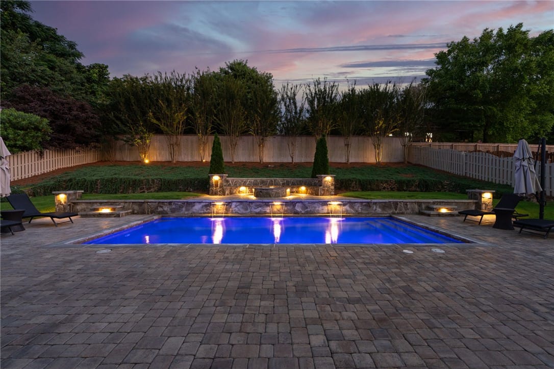 3205 Pinecrest Dr, Opelika, AL 36801, An illuminated backyard oasis with a pristine pool