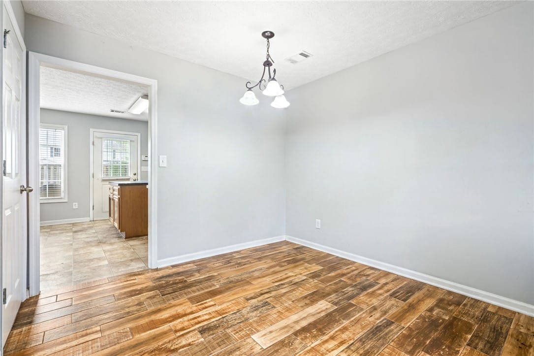 2107 Cobblestone Dr, Opelika, AL 36804, A refined dining space features LVT flooring and a