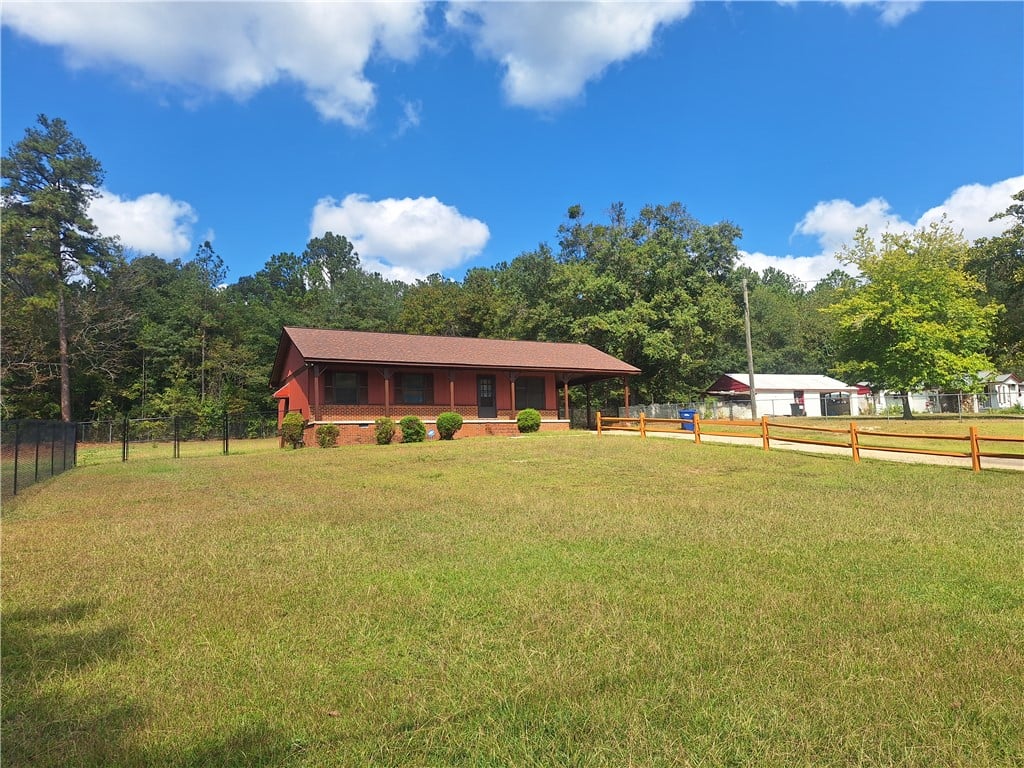 4316 24th St SW, Lanett, AL 36863, Mature trees frame a classic single-story country
