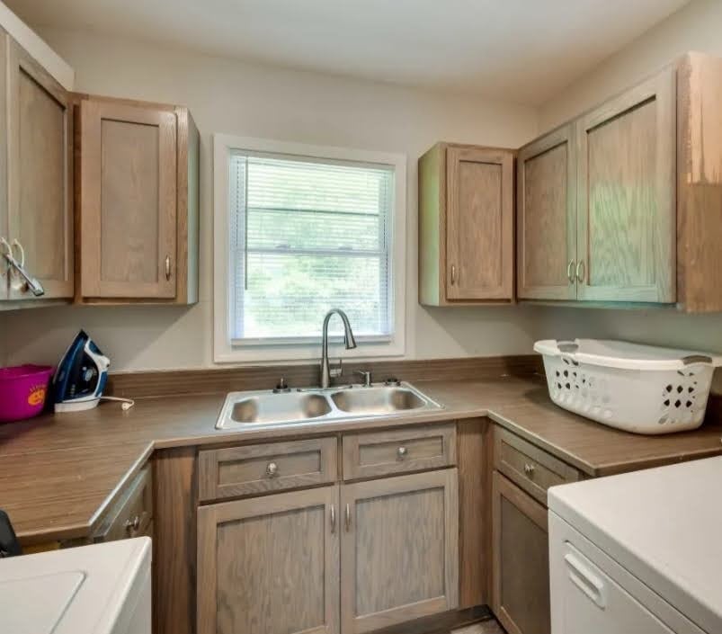 1904 HAGGINS, Tuskegee, AL, 36088, Functional laundry workspace features solid wood c