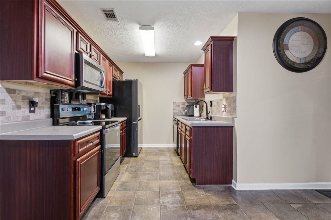 2125 Winding Oak Dr, Opelika, AL 36804, USA, A well-appointed kitchen features rich cabinetry,