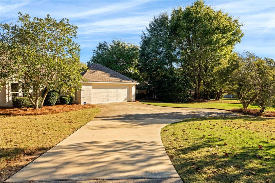 1388 Teaberry Ct, Auburn, AL 36830, Mature trees frame the concrete driveway leading t