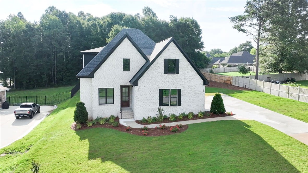 118 Coachmans Dr, Auburn, AL 36832, A striking white brick residence with a dark roofl