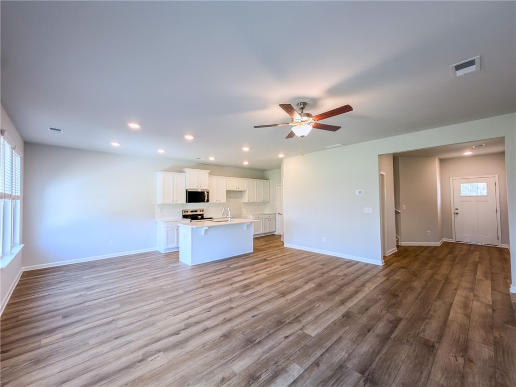 2553 Arlee Ave, Opelika, AL 36804, Gleaming wood-look floors anchor a sweeping, fluid